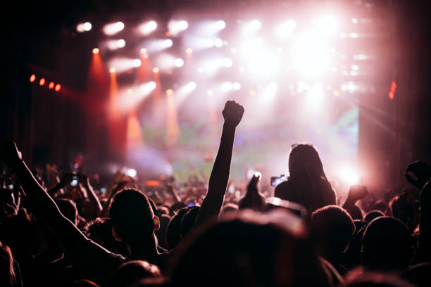 istock Cheering crowd at concert enjoying music performance 1155224334