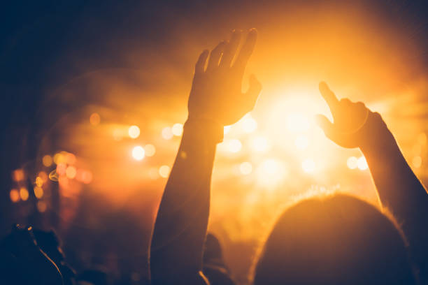 istock Cheering crowd at concert enjoying music performance 1155224353