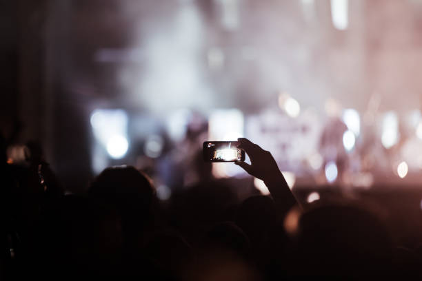 istock Cheering crowd at concert enjoying music performance 1155224358