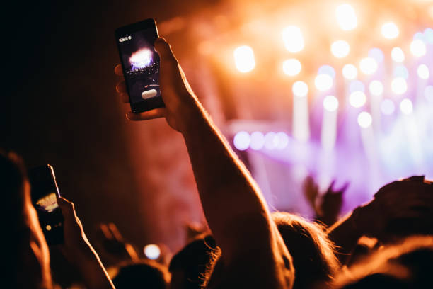 istock Cheering crowd at concert enjoying music performance 1155224385