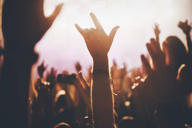 istock Cheering crowd at concert enjoying music performance 1155224399
