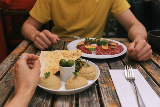 Couple Eating Lunch with Hummus and Risotto