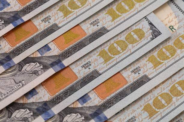 istock 100 dollar banknotes layed out preciesly 1155230398