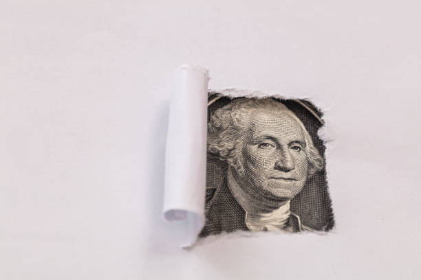 istock George Washington macro peeking through torn white paper 1155231306