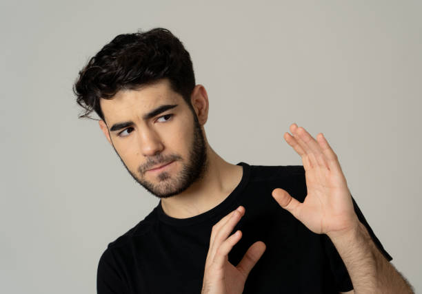 istock Young man feeling scared and shocked making fear anxiety gestures. Looking terrified and desperate trying to cover himself. Portrait with copy space. People and Human expressions and emotions. 1155232083