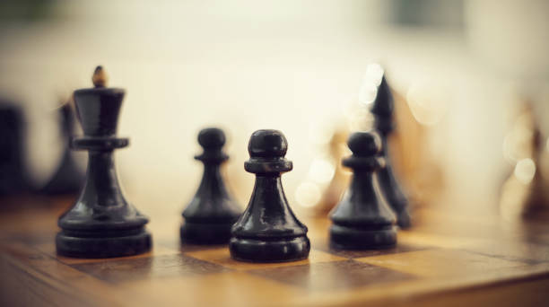 istock Wooden chess pieces on the chessboard. 1155234663