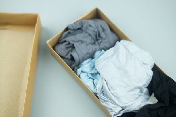 istock Many color men underwear in brown paper box package 1155235687