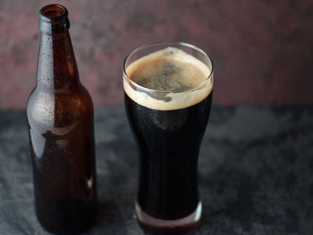 istock Beer bottle and glass with dark beer porter or stout 1155236036