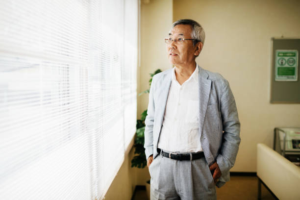 istock Mature Man Looking Out Hospital Window 1155236347