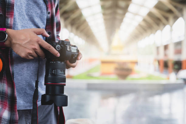 istock Asian man traveler with backpack holding camera in train station. 1155236600