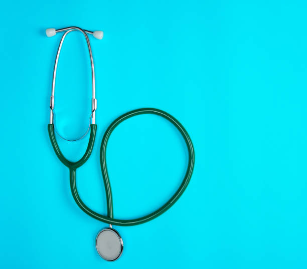 istock green medical stethoscope on blue background 1155237739