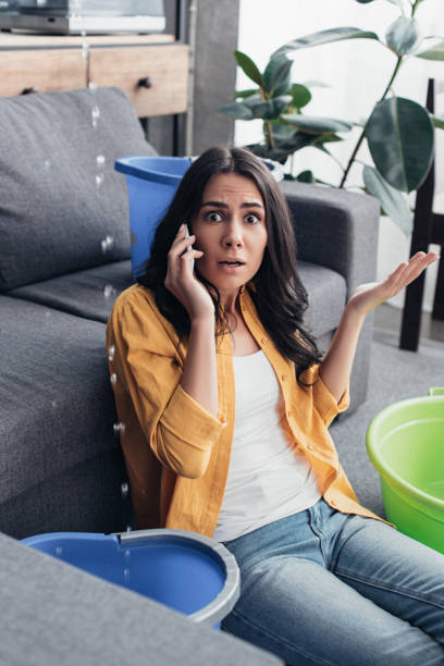 istock Shocked woman talking on phone and looking at camera 1155239476