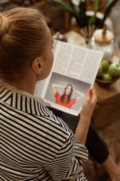 istock Diligent calm woman being busy with reading glance pages 1155240157