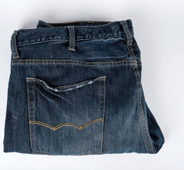 istock folded blue men's jeans on a white background, 1155240160