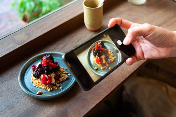 istock Holding a smartphone is shooting a cheese cake pie. 1155240220