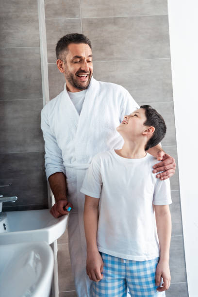istock happy father hugging son in bathroom during morning routine 1155240451