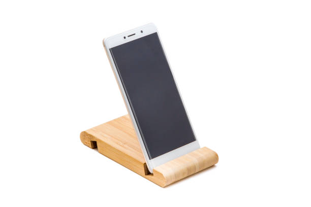 istock Wooden stand for smartphone isolated on white 1155240591