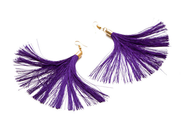 istock Earrings with purple threads on a white background 1155242358