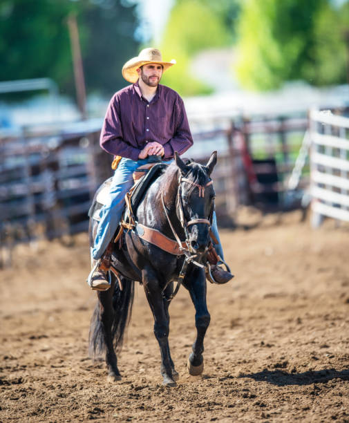 istock Cowboy riding at rodeo arena 1155242900