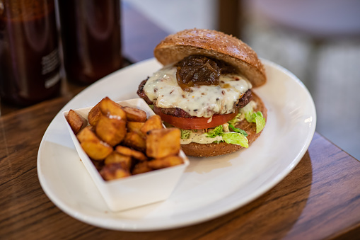 Close up of a homemade hamburger with spicy potatoes