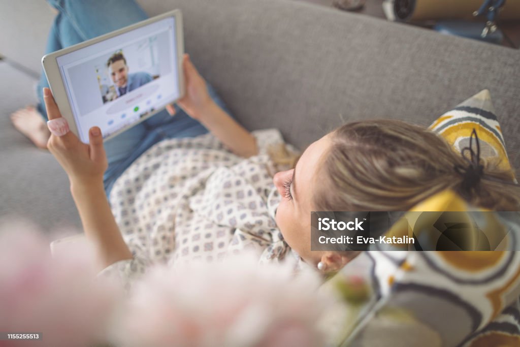 Young woman working at home Long-Distance Relationship Stock Photo