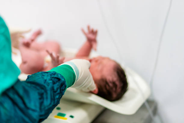 newborn baby being weighed
