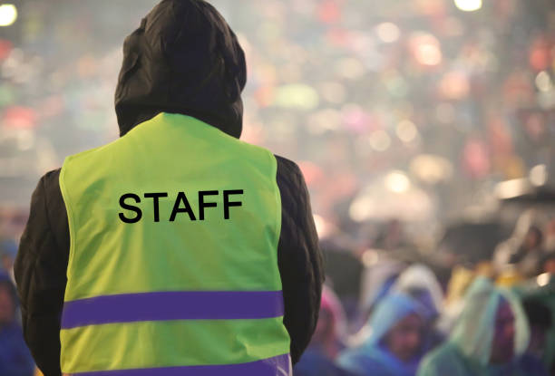 istock boy with yellow high visibility jacket and the text STAFF 1155256967