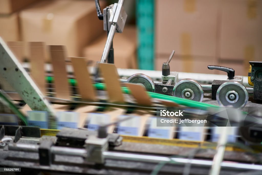 Fast and efficient printing Shot of a printing machine in a factory Packaging Stock Photo