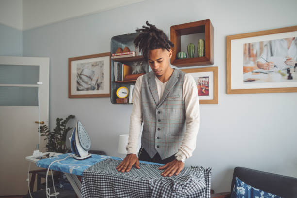 istock Young man ironing his shirt 1155257269