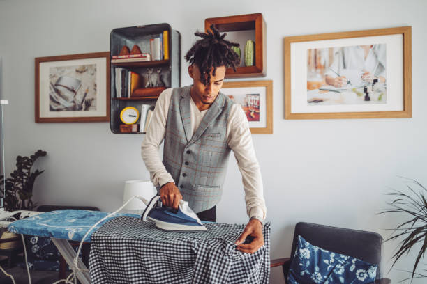 istock Young man ironing his shirt 1155257276