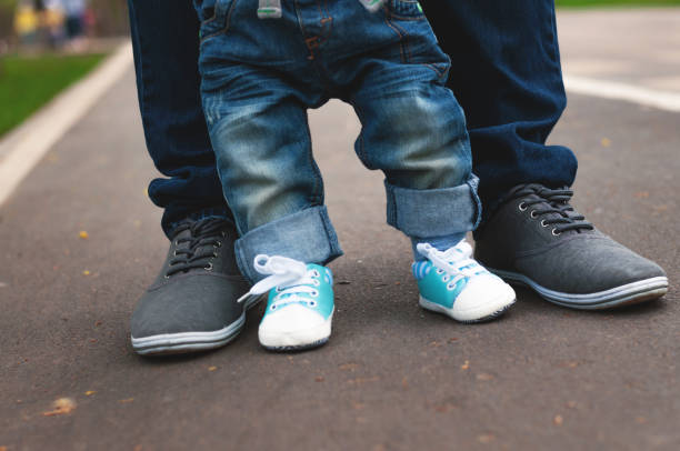 legs of child and adult. - healthy lifestyle nature sports shoe childhood imagens e fotografias de stock