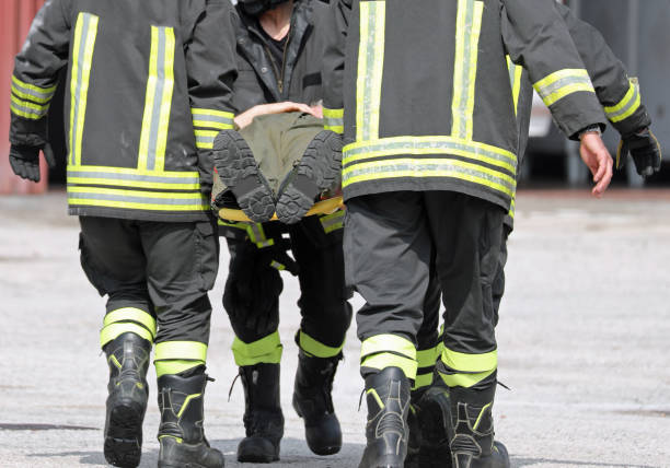 istock firefighters carrying an injured man on a stretcher 1155258407