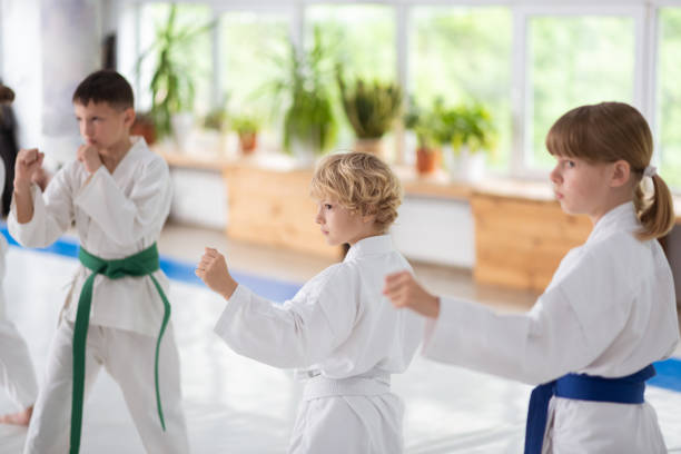 istock Boys and girl wearing white kimono practicing aikido 1155258510
