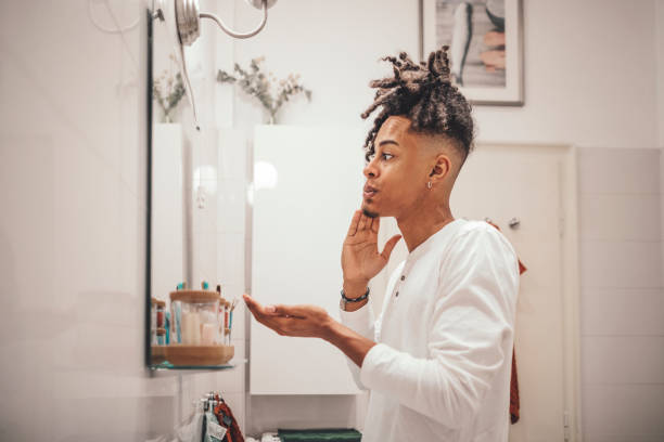 At home - young man brushing his teeth At home - young man brushing his teeth shaving stock pictures, royalty-free photos & images