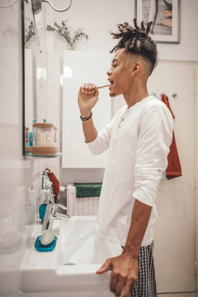 istock At home - young man brushing his teeth 1155258824