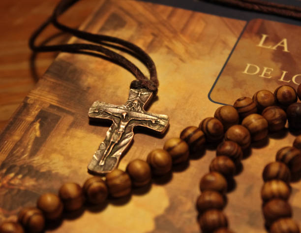 istock Crucifix and Wooden rosary on religious book 1155259040