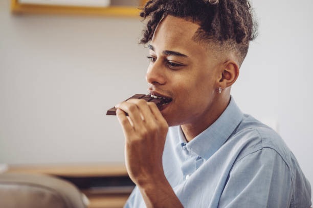At home - young man brushing his teeth At home - young man brushing his teeth black people eating stock pictures, royalty-free photos & images