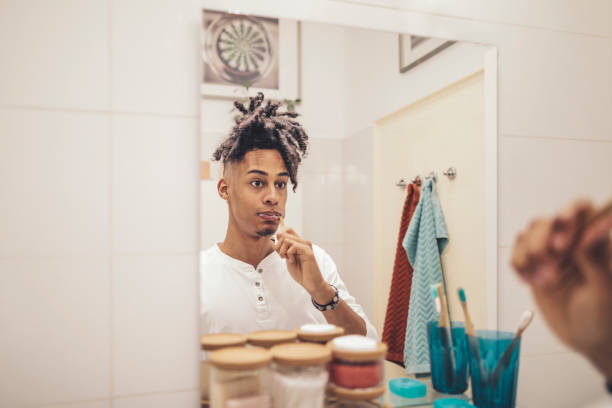 istock At home - young man brushing his teeth 1155259651