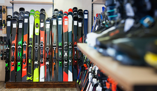 Variety of new colorful  alpine skis for sale in modern sports equipment store