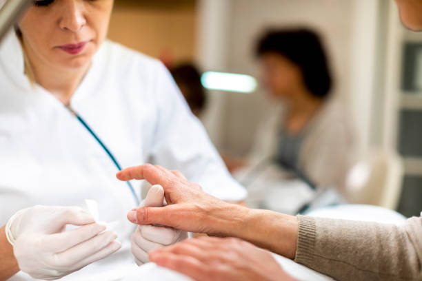 istock Manicurist preparing a woman's fingernails for painting 1155266846