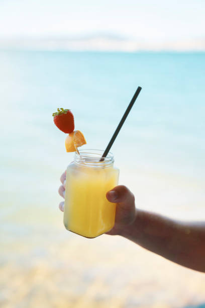 istock Drinking cocktail by the sea 1155267807