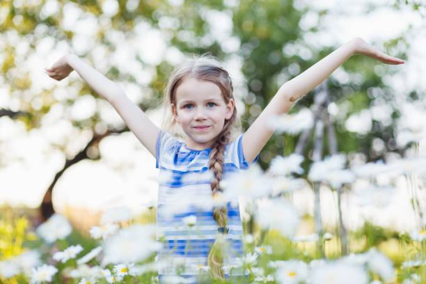 istock Little girl in a field among chamomile. 1155268340