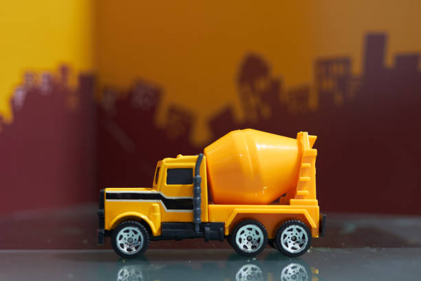 istock Yellow cement truck on blur city background,side view 1155271503