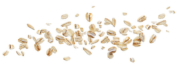 flying oat flakes isolated on white background with clipping path - oatmeal rolled oats oat raw imagens e fotografias de stock