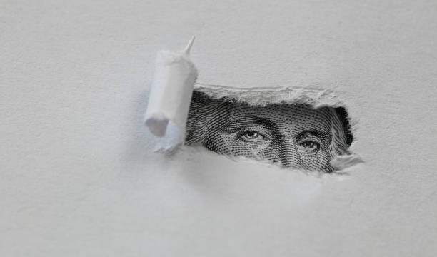 istock George Washington macro peeking through torn white paper 1155274235