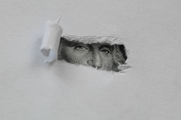 istock George Washington macro peeking through torn white paper 1155274244
