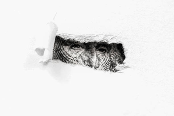 istock George Washington macro peeking through torn white paper 1155274247