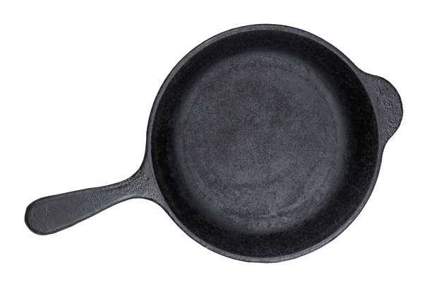 istock Old cast iron pan isolated on white background, top view 1155274294