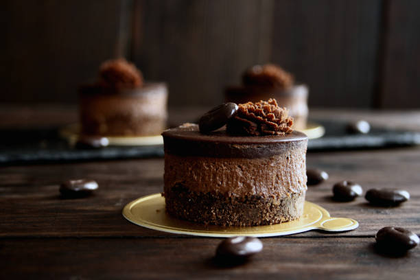 istock Mini chocolate cakes on wooden background 1155276944