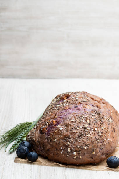 Blueberry  and chia seed bloomer on white wooden table